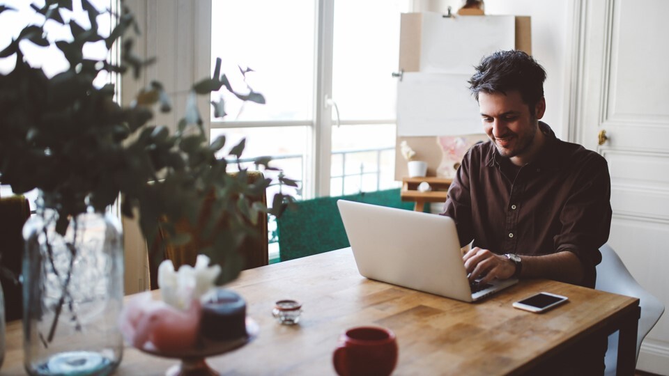 Image of man on computer for webinar